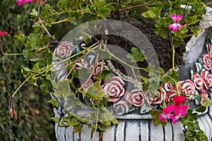 Suffered from vandals bowl or a vase of flowers. Flowerbed broken by hooligans in an urban environment