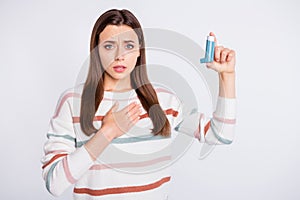 Suffering of bronchospasm lady going to inhale medication wear striped pullover isolated white background photo