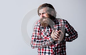 Suffering Caucasian Man. brutal bearded hipster has heartache. male feel pain in heart. casual male need medical care