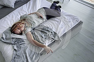 Suffering female person lying on bed