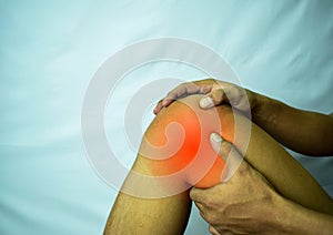 Suffering from joint pain with red spot. Hands on leg as hurt from Arthritis. Osteoarthritis knee disease concept photo