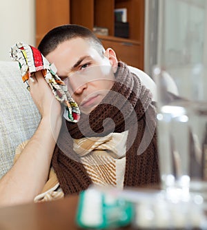 Suffering man stuping towel to head