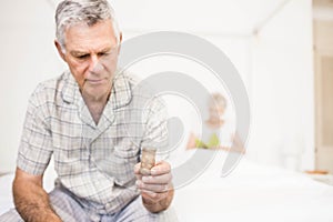 Suffering senior man taking pills