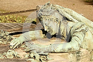 Suffering woman sculpture at Monumental Cemetery, Milan