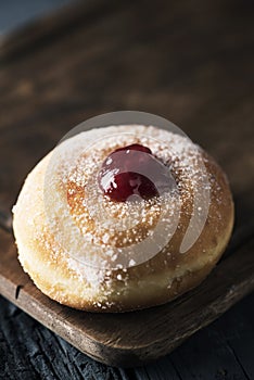 a sufganiyah, a Jewish donut filled with strawberry jelly