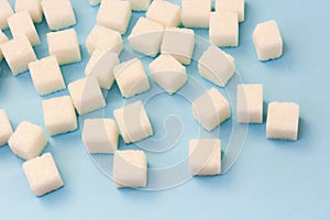 Sugar addiction, insulin resistance, unhealthy diet, sugar cubes on blue background, diabetes protection concept, top view