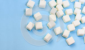 Sugar addiction, insulin resistance, unhealthy diet, sugar cubes on blue background, diabetes protection concept, top view