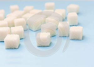 Sugar addiction, insulin resistance, unhealthy diet, sugar cubes on blue background, diabetes protection concept, top view