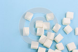 Sugar addiction, insulin resistance, unhealthy diet, sugar cubes on blue background, diabetes protection concept, top view