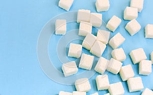 Sugar addiction, insulin resistance, unhealthy diet, sugar cubes on blue background, diabetes protection concept, top view