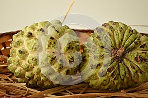 The sugar-apple or sweet-sop. Edible fruit of Annona squamosa. Thick rind knobby segments. Flesh is sweet, taste like custard. photo