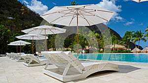 Sugar beach Saint Lucia ,white tropical beach palm trees and luxury beach chairs St Lucia Caribbean