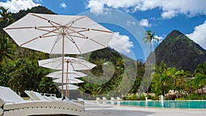 Sugar beach Saint Lucia ,white tropical beach palm trees and luxury beach chairs St Lucia Caribbean