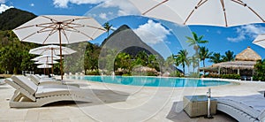 Sugar beach Saint Lucia ,white tropical beach palm trees and luxury beach chairs St Lucia Caribbean