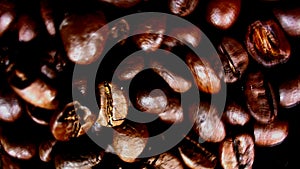 Sugar being pored onto a pile of coffee. Against black background