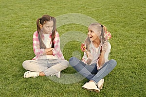 Sugar and calories. Joyful cheerful friends eating sweets outdoors. Candy shop. Lollipop treats. Candy means happiness