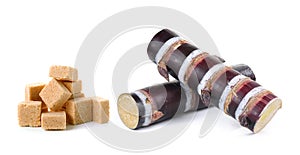 Sugar cane and sugar cube on white background