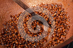 Sugar coated almonds being hand roasted.