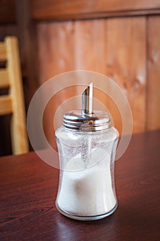 Sugar container on brown table