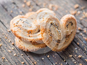 Sugar cookie curls with poppy seed puff pastry on wooden background. Confectionery for the recipe. Pastries, dessert