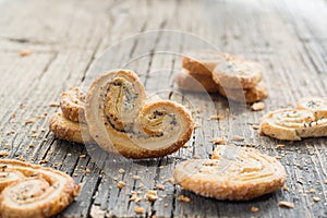 Sugar cookie curls with poppy seed puff pastry on wooden background. Confectionery for the recipe. Pastries, dessert