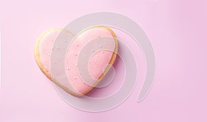 Sugar cookie in heart shape, on pink background. Valentine, love, romance concept.