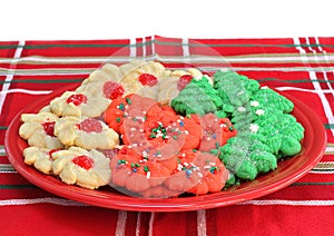 Sugar cookies decorated for Christmas on a red plate