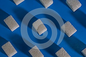 Sugar cubes on a blue background. Abstract background