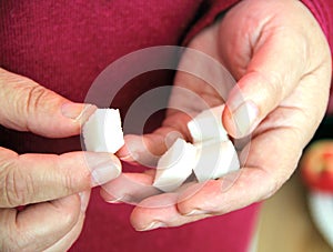 Sugar cubes in the hands