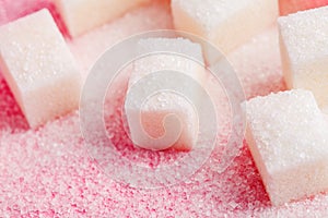 Sugar cubes on pastel pink, macro food