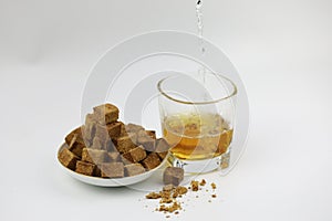 Sugar cubes on plate and Glass cup with water