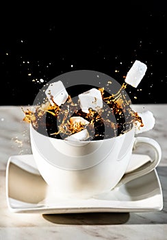 Sugar cubes thrown into a cup of coffee