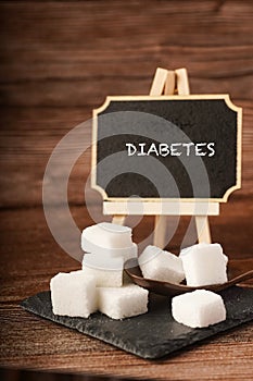 Sugar cubes with wooden spoon