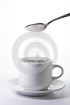 Sugar falling from a spoon