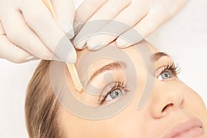 Sugar hair removal from woman body. Wax epilation spa procedure. Procedure beautician female. Eyebrow photo