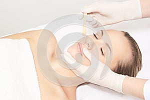 Sugar hair removal from woman body. Wax epilation spa procedure. Procedure beautician female. Mustache