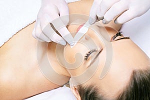 Sugar hair removal from woman body. Wax epilation spa procedure. Procedure beautician female. Mustache