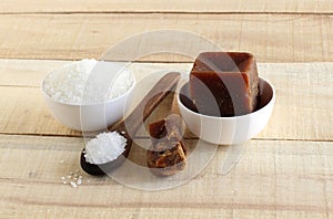 Sugar and Healthy Sweetener Jaggery in Bowls and on Wooden Spoons