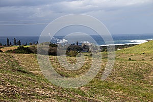 Sugar Mill Releasing Steam from its Boilers and Chimneys