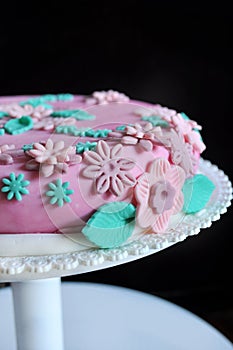 Sugar paste flowers on pink cake