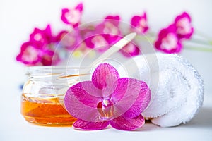 Sugar paste or wax honey for hair removing with wooden waxing spatula sticks. flower background - depilation and beauty