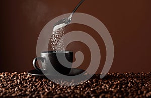 Sugar is poured into a cup of coffee
