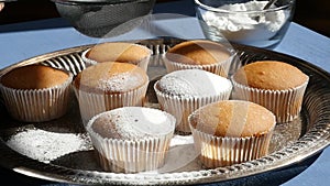 Sugar Powder Being Sprinkled on Muffins