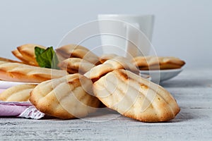 Sugar powdered madeleines with coffee and lemon. Selective focus