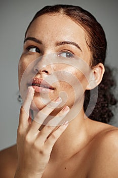 Sugar scrub, face and lips of woman in studio isolated on a gray background. Thinking, cosmetics and skincare of female