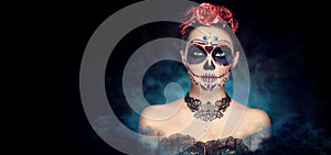 Sugar skull makeup. Halloween party, traditional Mexican carnival, Santa Muerte. Beautiful young woman costume photo