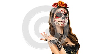 Sugar skull makeup. Halloween party, traditional Mexican carnival, Santa Muerte. Beautiful young woman costume photo