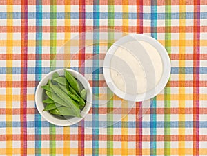 Sugar snap peas in a bowl with ranch dressing