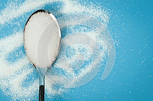 Sugar spoon blue background.