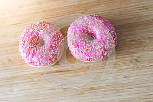 Sugar addiction: Close up of sugar sprinkled pink donut
